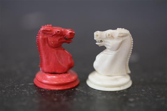 A 19th century bone chess set (two red pawns differ)